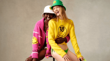 Two models in The Smiley Company apparel in pink, yellow, white and green