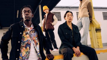 Models pose outside near an underpass wearing denim