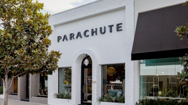 Storefront painted white with "Parachute" in black lettering