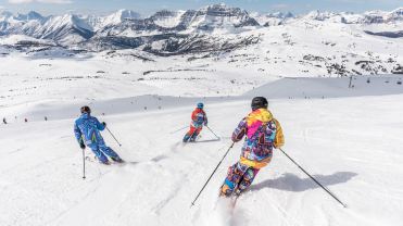 People skiing down a snowy mountain.